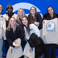 group of friends show sweatshirt in front of GV backdrop